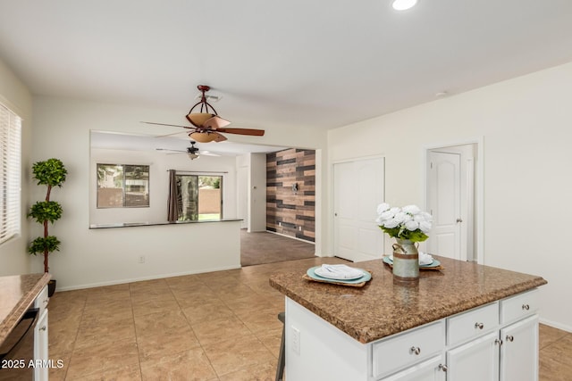 871 E Melanie St, San Tan Valley, AZ 85140 - kitchen with ceiling fan, white cabinetry, baseboards, dark countertops, and a kitchen island