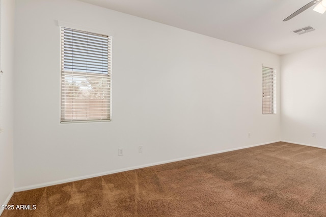 871 E Melanie St, San Tan Valley, AZ 85140 - spare room featuring carpet floors, baseboards, a ceiling fan, and healthy amount of natural light