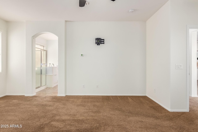 871 E Melanie St, San Tan Valley, AZ 85140 - empty room with carpet floors, arched walkways, ceiling fan, baseboards, and a smoke detector