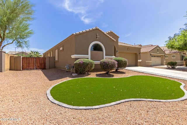 871 E Melanie St, San Tan Valley, AZ 85140 - mediterranean / spanish-style house with an attached garage, a gate, stucco siding, and a tile roof