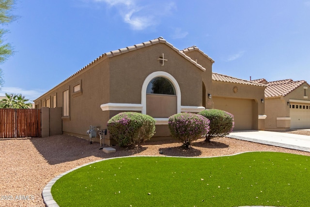 871 E Melanie St, San Tan Valley, AZ 85140 - view of front facade with stucco siding, an attached garage, fence, a tile roof, and concrete driveway