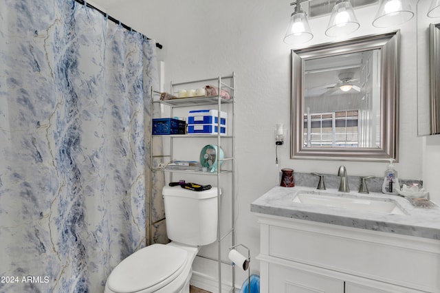 bathroom featuring walk in shower, ceiling fan, vanity, and toilet