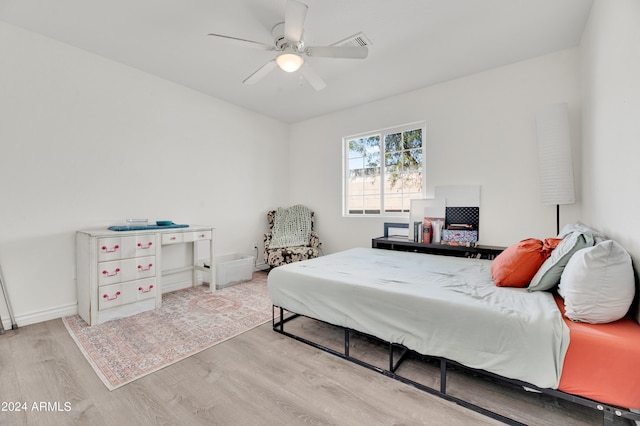 bedroom with ceiling fan and light hardwood / wood-style flooring