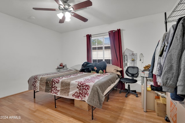 bedroom with hardwood / wood-style flooring and ceiling fan