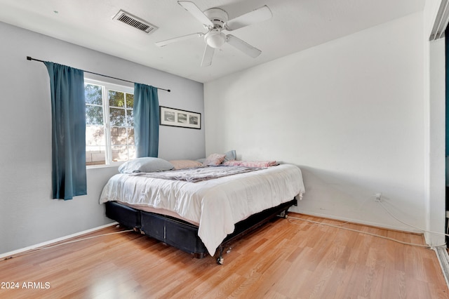 bedroom with ceiling fan and hardwood / wood-style floors