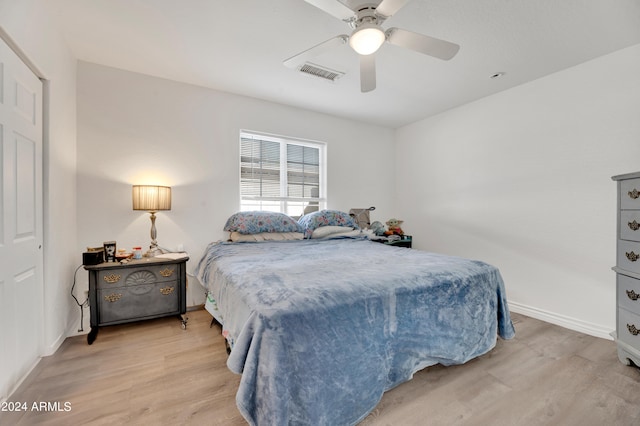 bedroom with ceiling fan and light hardwood / wood-style floors