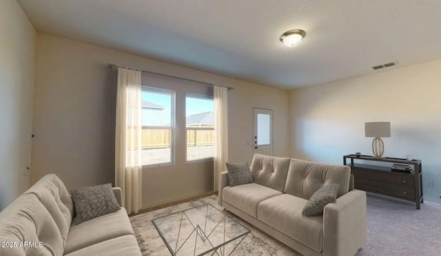 living room featuring light carpet and visible vents