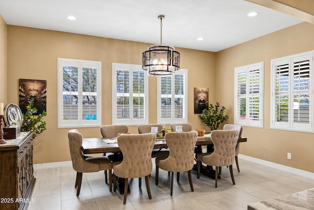 tiled dining space featuring an inviting chandelier