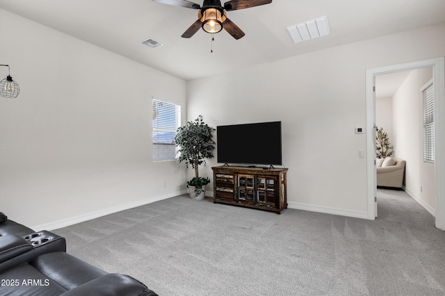 carpeted living room featuring ceiling fan