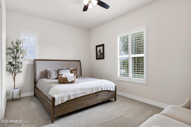 carpeted bedroom featuring multiple windows and ceiling fan