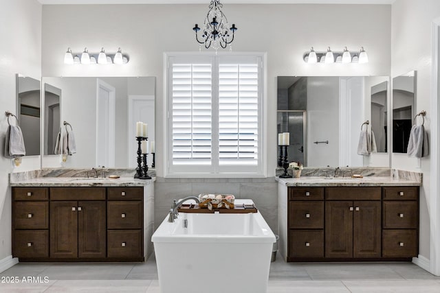 bathroom with vanity, tile walls, tile patterned floors, and plus walk in shower