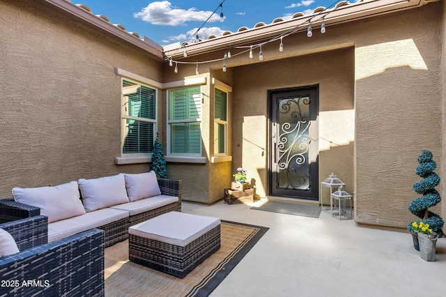 entrance to property with outdoor lounge area and a patio area