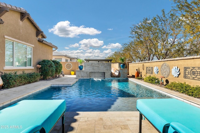 view of pool with pool water feature and a patio