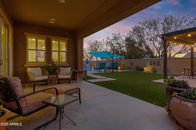 patio terrace at dusk with a yard and an outdoor hangout area