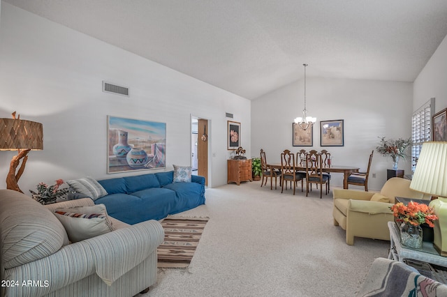 carpeted living room with high vaulted ceiling and a notable chandelier