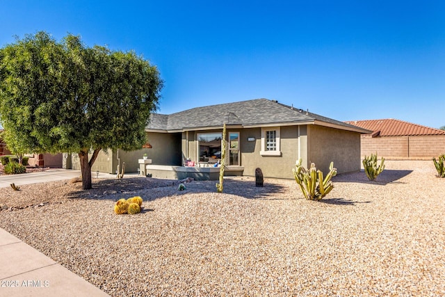 ranch-style home with fence and stucco siding