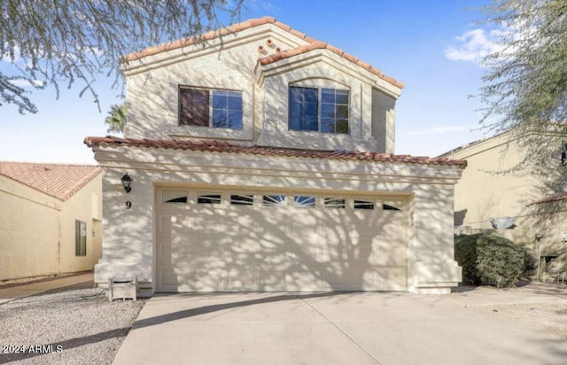 mediterranean / spanish-style house with a garage