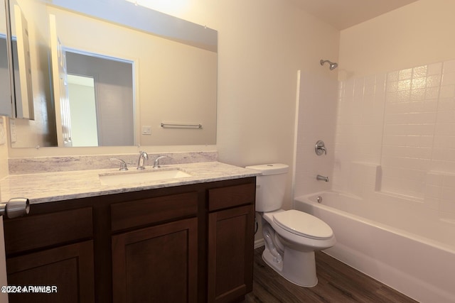 full bathroom featuring wood-type flooring, tub / shower combination, vanity, and toilet