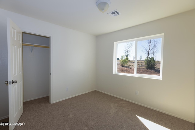 unfurnished bedroom with a closet and carpet