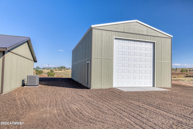 view of outbuilding with central air condition unit and a garage