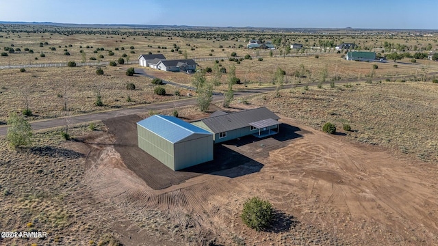 birds eye view of property with a rural view