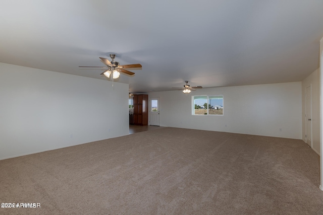 unfurnished living room with carpet flooring and ceiling fan