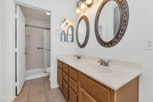 bathroom with toilet, tile patterned flooring, vanity, and walk in shower