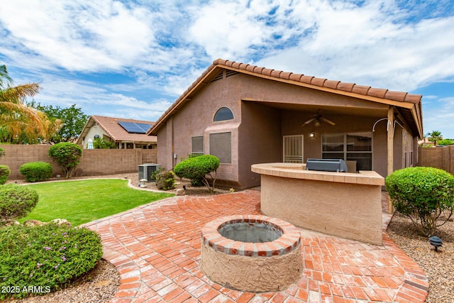 view of patio with an outdoor kitchen, cooling unit, a grill, ceiling fan, and a fire pit