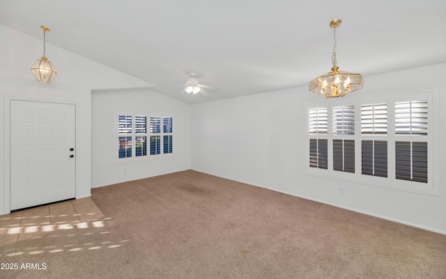 interior space featuring vaulted ceiling and ceiling fan with notable chandelier