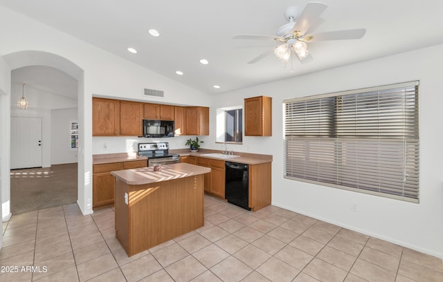 kitchen with light tile patterned floors, black appliances, a kitchen island, ceiling fan, and sink