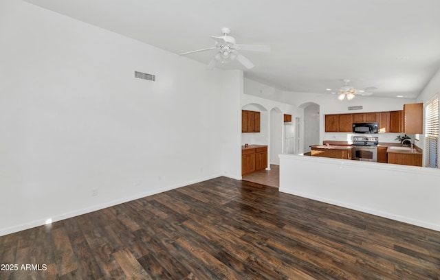 kitchen with vaulted ceiling, ceiling fan, stainless steel electric range oven, dark hardwood / wood-style flooring, and sink