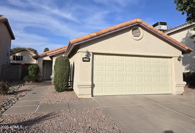 view of front of property featuring a garage and central air condition unit