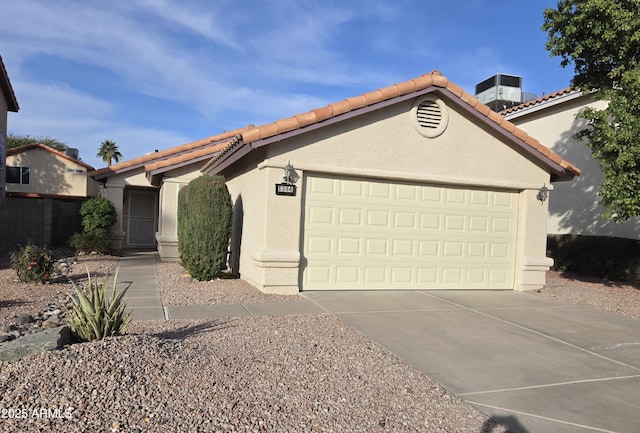 view of front of house featuring central AC and a garage