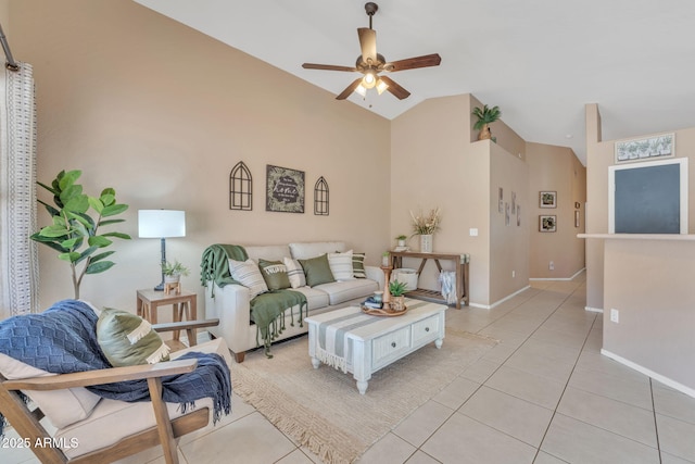 living room featuring vaulted ceiling, ceiling fan, and light tile patterned floors