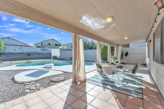 view of patio with a fenced in pool