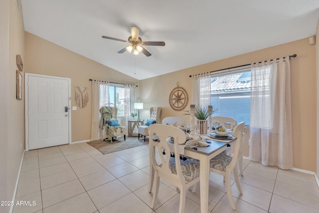 tiled dining area with vaulted ceiling and ceiling fan