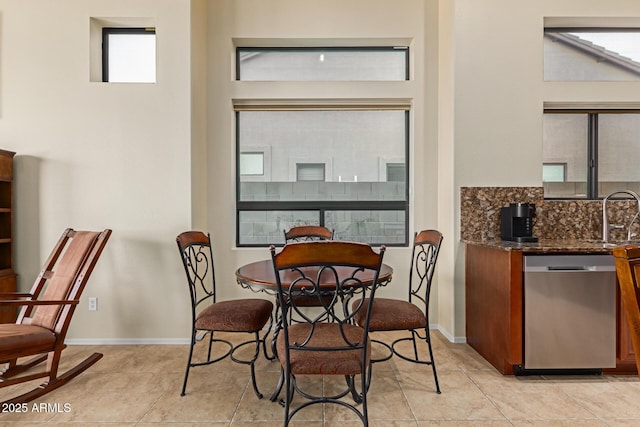 tiled dining area featuring sink