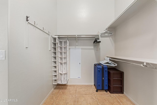 spacious closet with light tile patterned floors