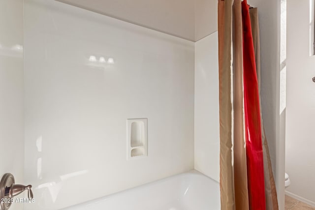 bathroom with shower / bathtub combination with curtain and toilet