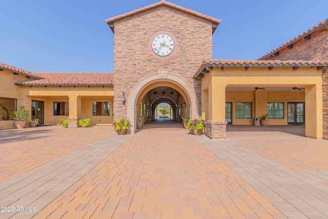 exterior space featuring ceiling fan