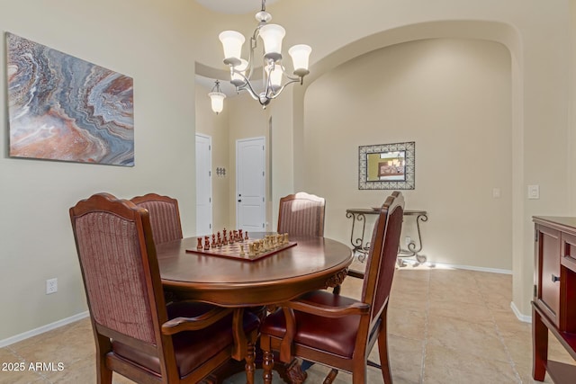 tiled dining area with an inviting chandelier