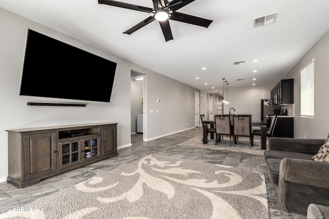 living room featuring sink and ceiling fan