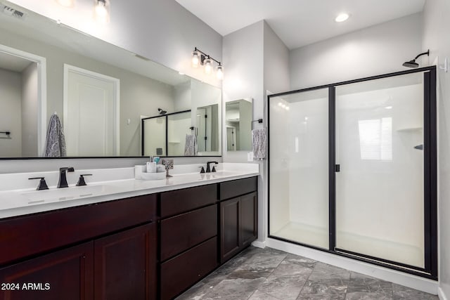 bathroom with vanity and a shower with shower door