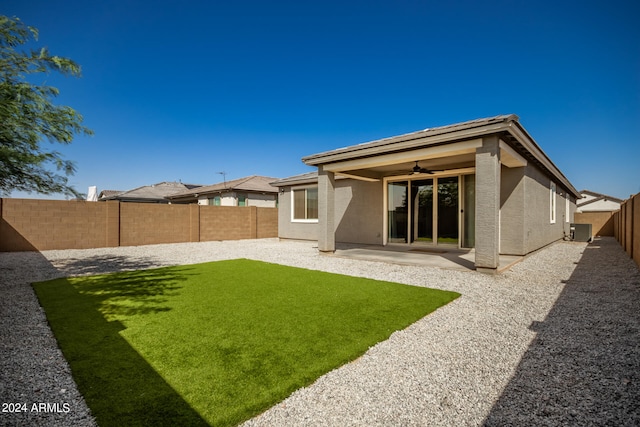 rear view of house featuring ceiling fan, a yard, a patio area, and central AC