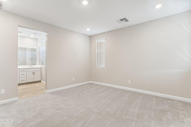 21228 N 58th St, Phoenix, AZ 85054 - spare room with light colored carpet, baseboards, recessed lighting, and a sink