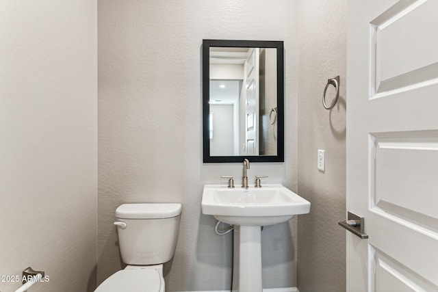 21228 N 58th St, Phoenix, AZ 85054 - bathroom featuring toilet and a textured wall