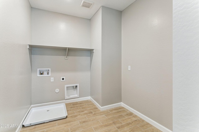21228 N 58th St, Phoenix, AZ 85054 - laundry area with hookup for an electric dryer, gas dryer hookup, wood finished floors, washer hookup, and baseboards
