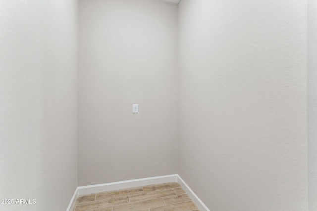 21228 N 58th St, Phoenix, AZ 85054 - laundry room featuring baseboards and light wood-type flooring