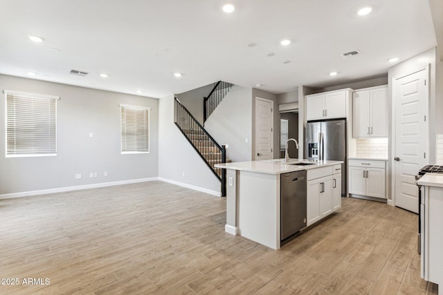 21228 N 58th St, Phoenix, AZ 85054 - kitchen featuring dishwasher, a sink, light countertops, light wood-style flooring, and tasteful backsplash