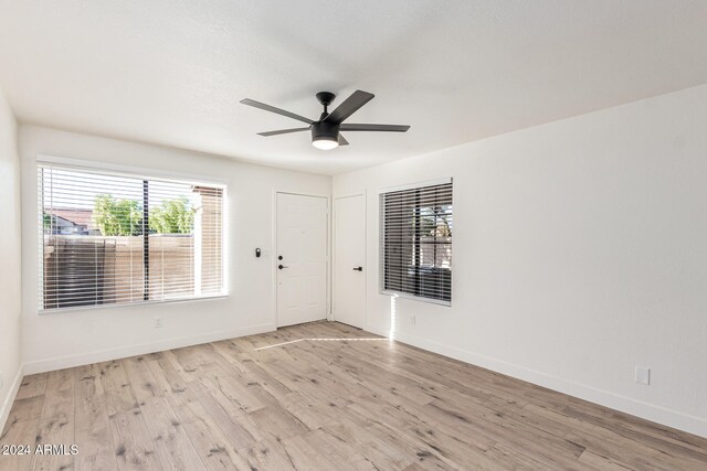 unfurnished room with light hardwood / wood-style flooring and ceiling fan